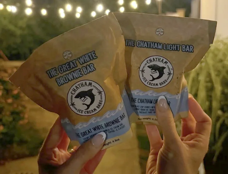 Two bars in their pouches held up under string lights outside Buffy's after dinner